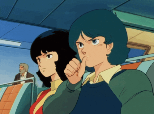 a man and a woman are sitting next to each other and one of them is holding her finger to her mouth