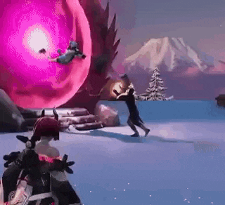 a man is standing in the snow in front of a giant purple ball .
