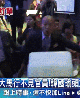 a group of people are gathered in a room with chinese writing