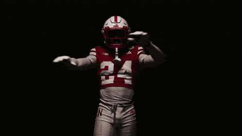 a football player wearing a red jersey with the number 24