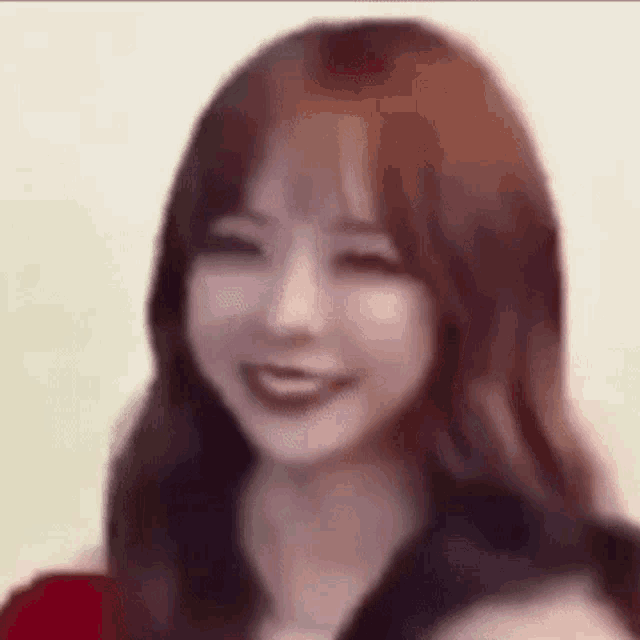 a close up of a woman 's face with a blurred background .