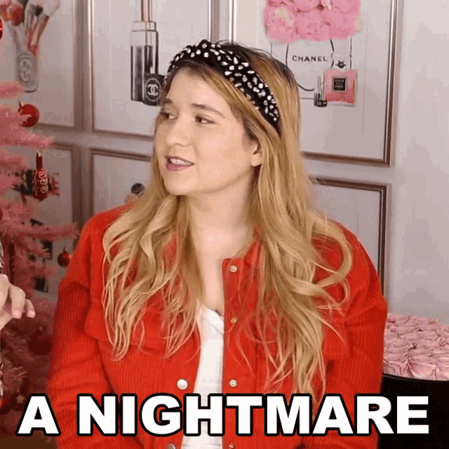 a woman in a red jacket says " a nightmare " in front of a pink christmas tree