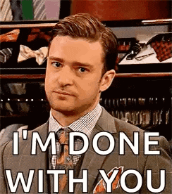 a man in a suit and tie is making a funny face and saying `` i 'm done with you ''