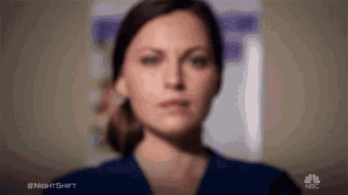 a blurry picture of a woman 's face in front of a poster .