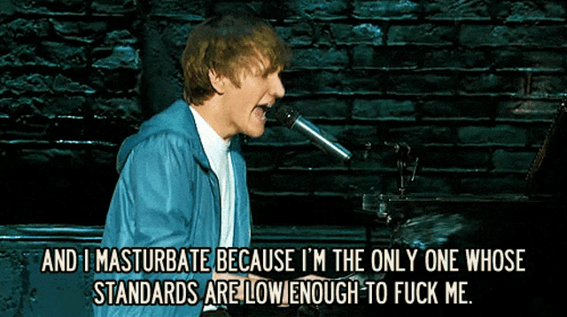 a man singing into a microphone with the words and i masturbate below