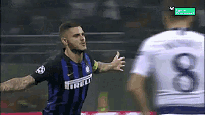 a soccer player wearing an irelli jersey is celebrating a goal against another player .