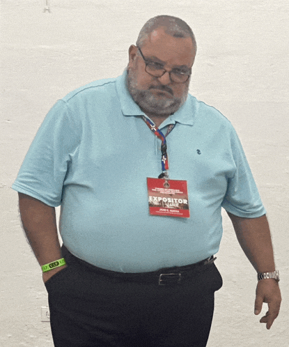 a man wears a lanyard with a tag that says expositor