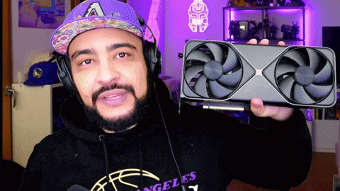 a man wearing headphones and a hoodie that says angeles holds a fan