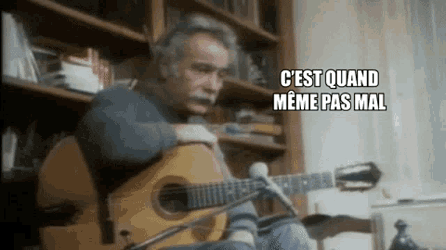 a man playing a guitar with the words " c'est quand meme pas mal " written above him