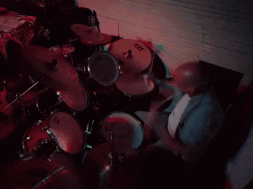 a man playing drums with a meinl cymbal
