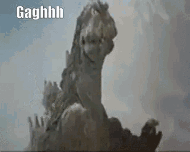 a close up of a statue of a dinosaur with the words `` gaghhh '' written on it .