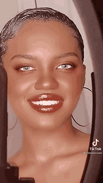 a close up of a woman 's face with tiktok written on the bottom left