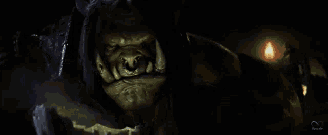 a close up of a monster 's face in a dark cave