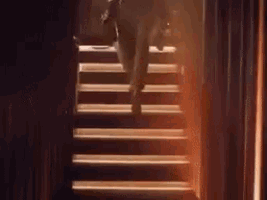 a person is walking up a set of stairs .