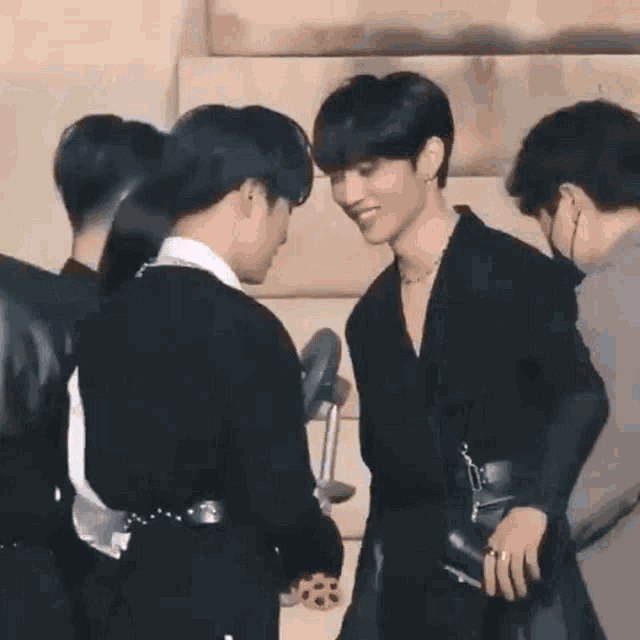 a group of young men are standing next to each other in a room .