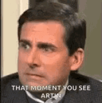 a man in a suit and tie is making a funny face and saying `` that moment you see artin '' .