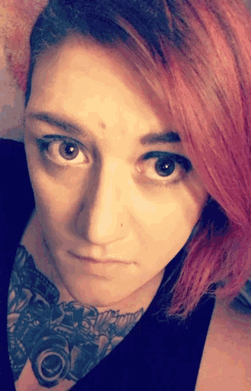 a close up of a woman 's face with a tattoo on her neck that says ' nikon '
