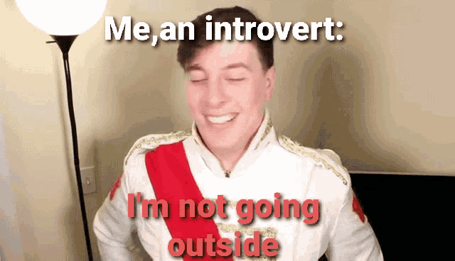 a man in a white jacket with a red sash says " me an introvert "