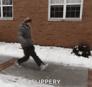 a person is walking down a sidewalk in the snow .