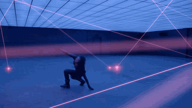 a person is dancing in a dark room with a lot of red lights