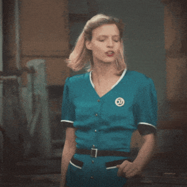 a woman in a blue dress with a badge on her chest