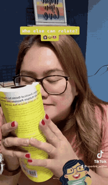 a woman wearing glasses is reading a book with a tiktok sticker above her head