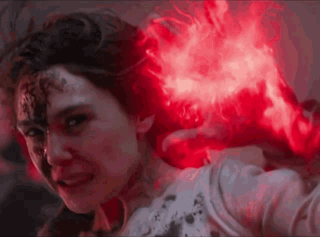 a close up of a woman with red lights coming out of her head .