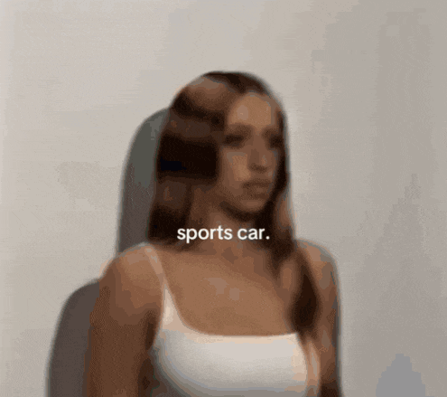 a woman in a white tank top with the words sports car written above her