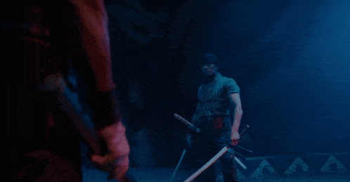 a woman in a red dress is holding a sword in a dark room