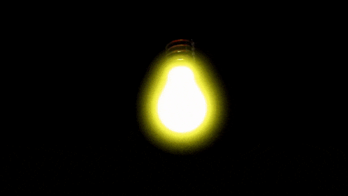 a light bulb is glowing in the dark