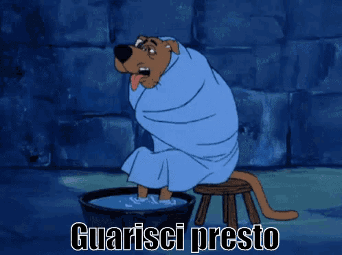 scooby doo is wrapped in a towel and sitting on a stool