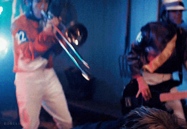 a man is playing a trombone with the number 2 on his jersey