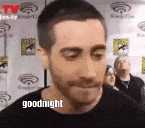 a man with a beard is making a funny face and saying goodnight .