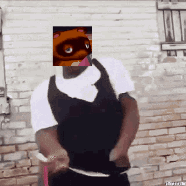 a man is standing in front of a brick wall with a picture of a teddy bear on his face ..