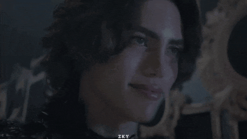 a blurred image of a person with zky written on the bottom left