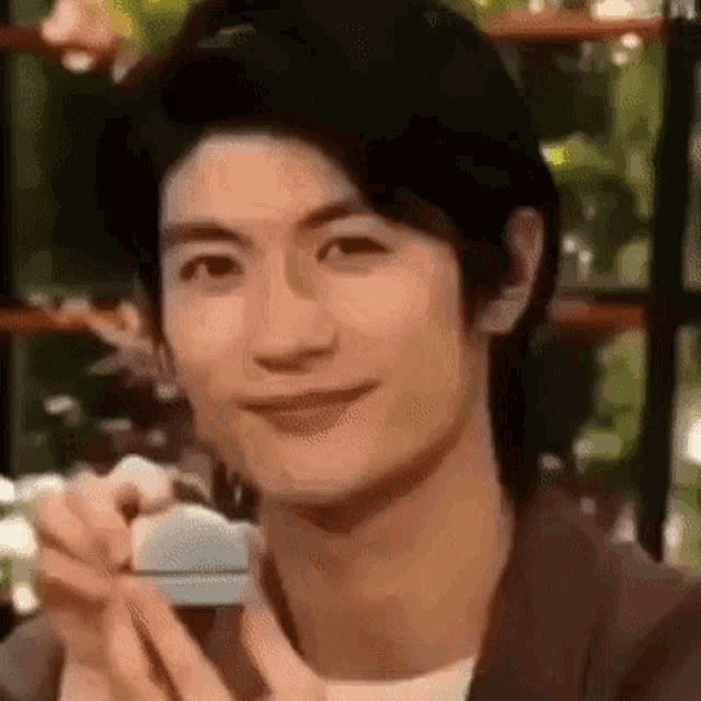 a close up of a man holding a piece of soap in his hand .
