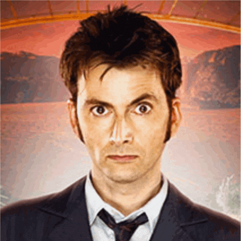 a man wearing a suit and tie looks at the camera