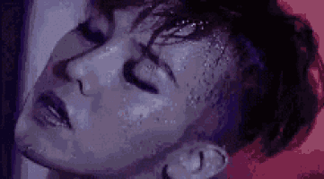 a close up of a man 's face with water coming out of his eyes .