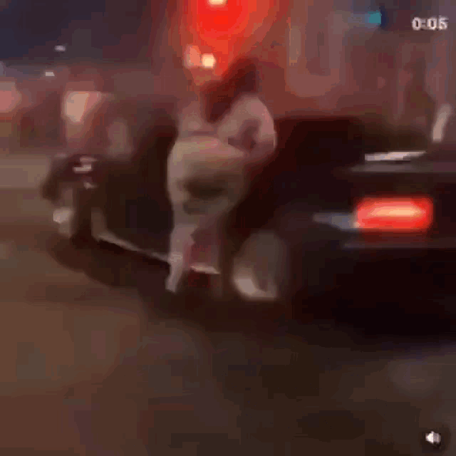 a blurry picture of a person riding a motorcycle on a street at night