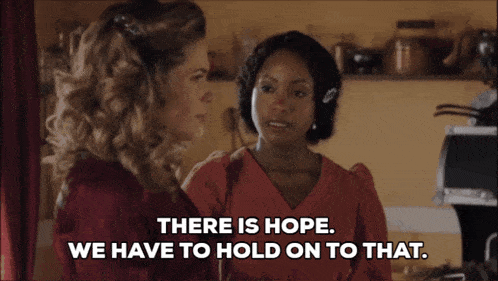 two women standing next to each other with the words " there is hope we have to hold on to that " above them