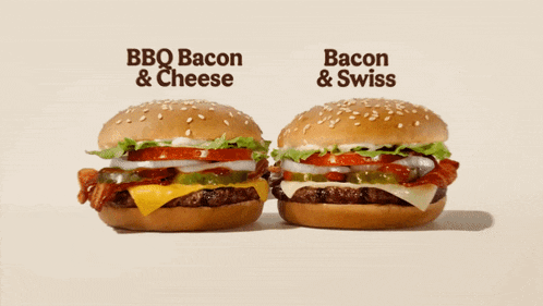 two bbq bacon and cheese hamburgers are next to each other on a table