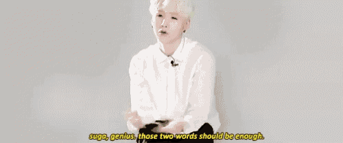 a young man in a white shirt says " suga genius those two words should be enough " .