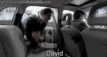 a man in a car with the name david on the back
