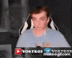 a man is sitting in a chair in front of a computer monitor .