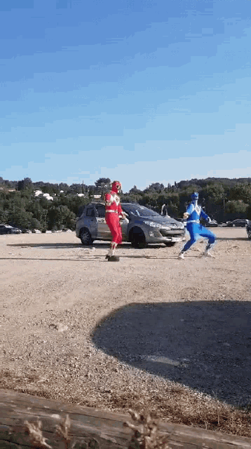 two power rangers in a parking lot with a car in the background