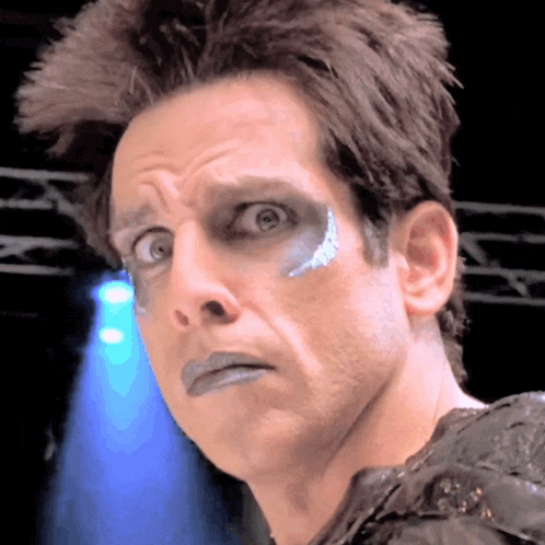 a close up of a man 's face with blue paint on his face