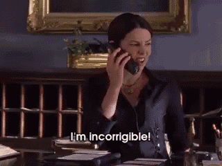 a woman talking on a cell phone with the words i 'm incorrigible behind her