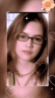 a blurry picture of a woman wearing glasses and a flower