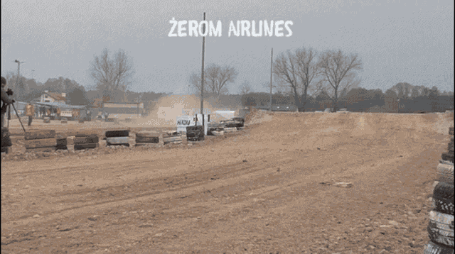 a car is driving on a dirt road with zerom airlines written on the bottom