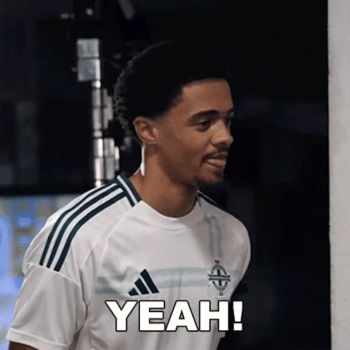 a man wearing a white adidas shirt is saying yeah
